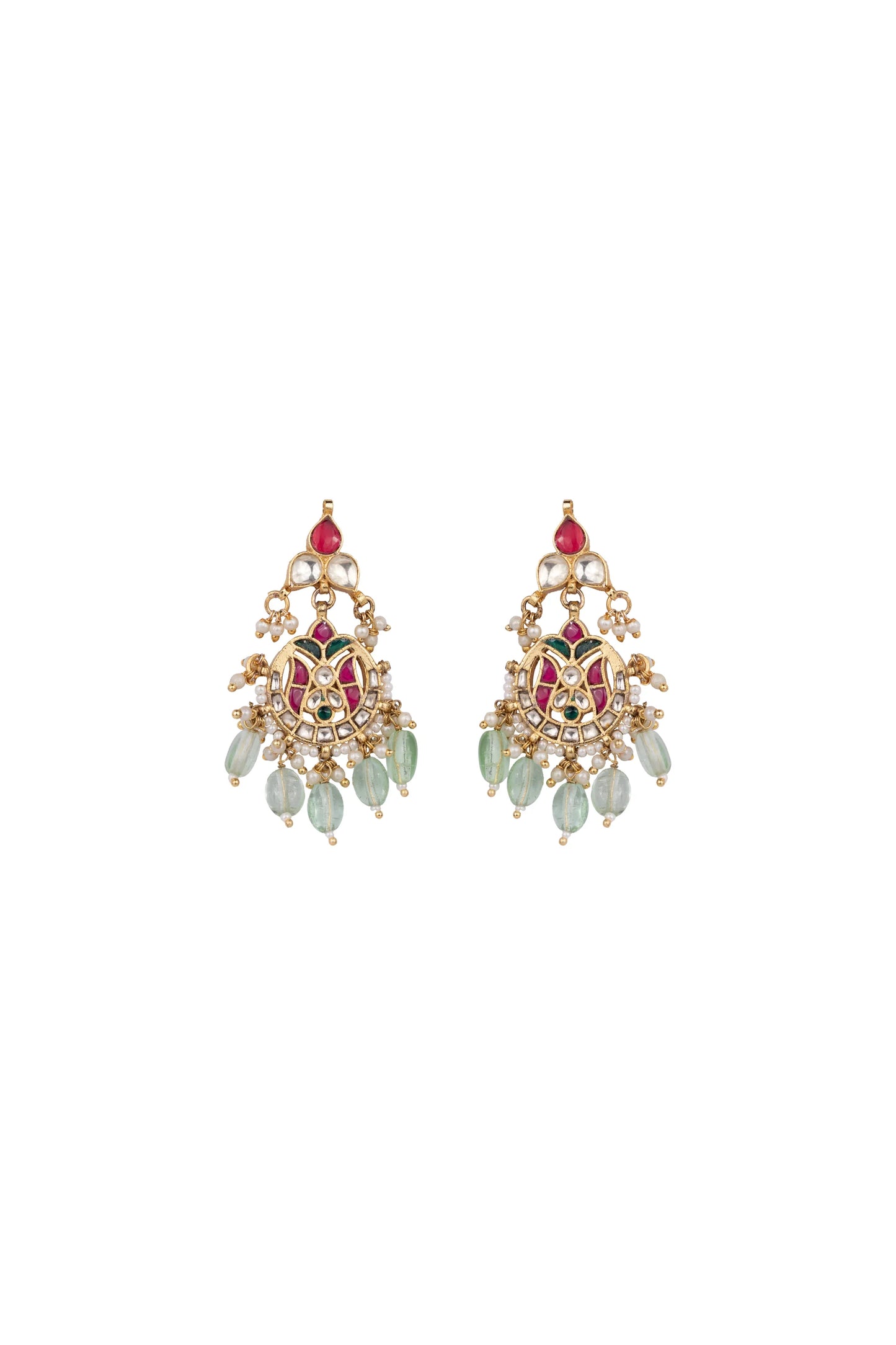 Artistic close-up of a woman in warm light wearing statement earrings with layered detailing and a festive outfit.