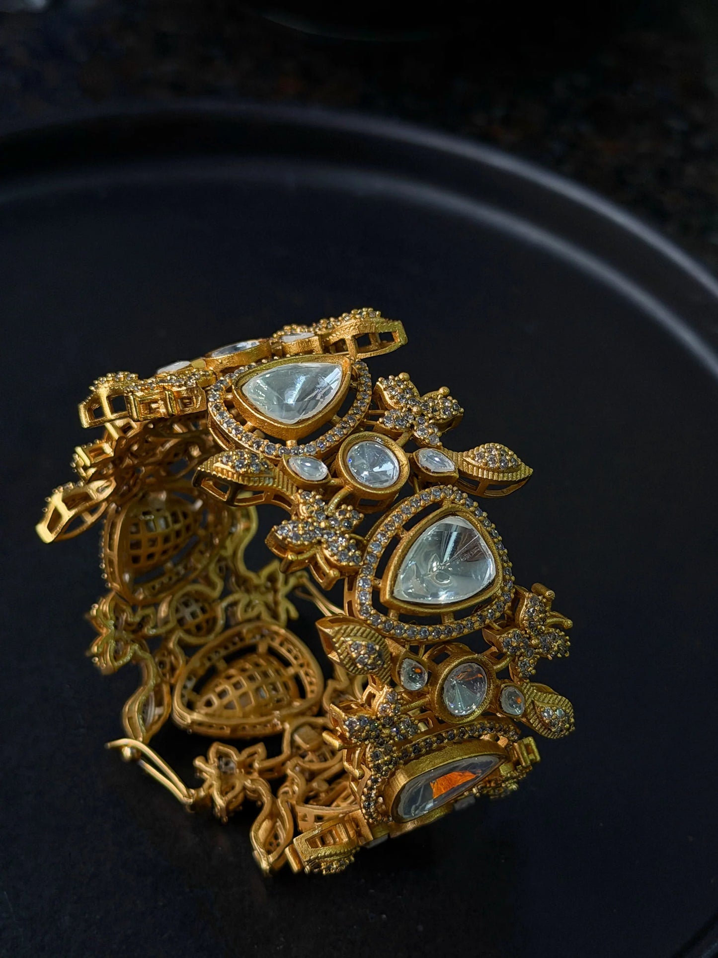 Premium gold bangle with kundan and diamond-like stones in ornate floral pattern