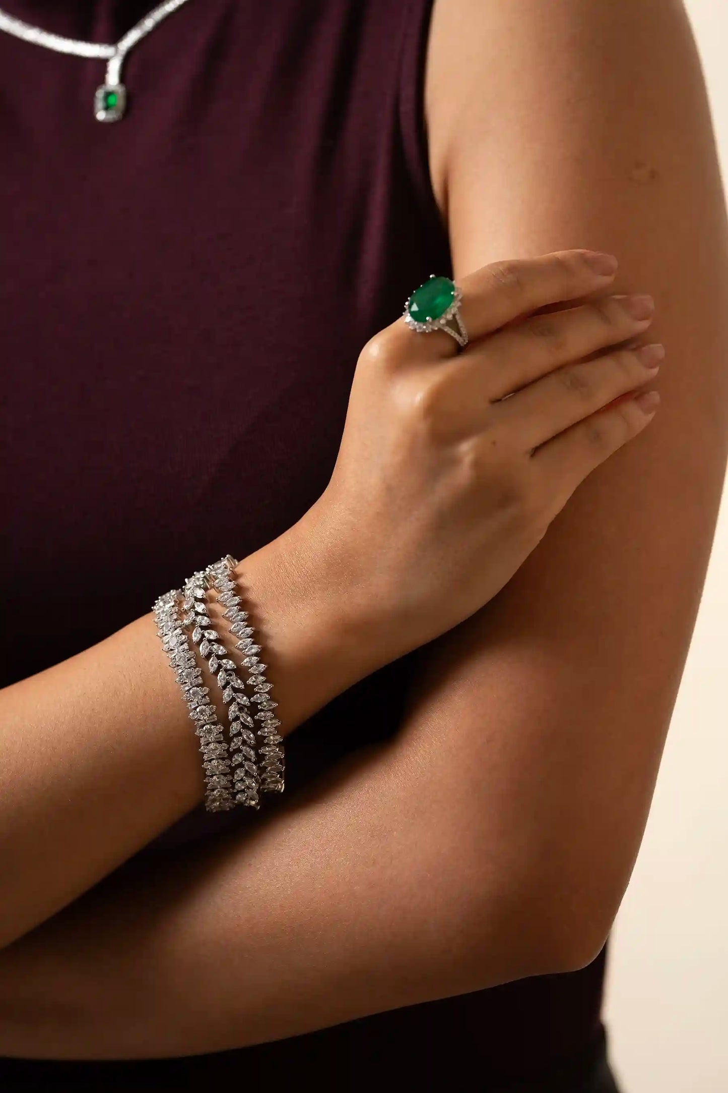 Macro close-up of oval emerald ring with diamond halo and split shank band, luxury statement jewelry piece