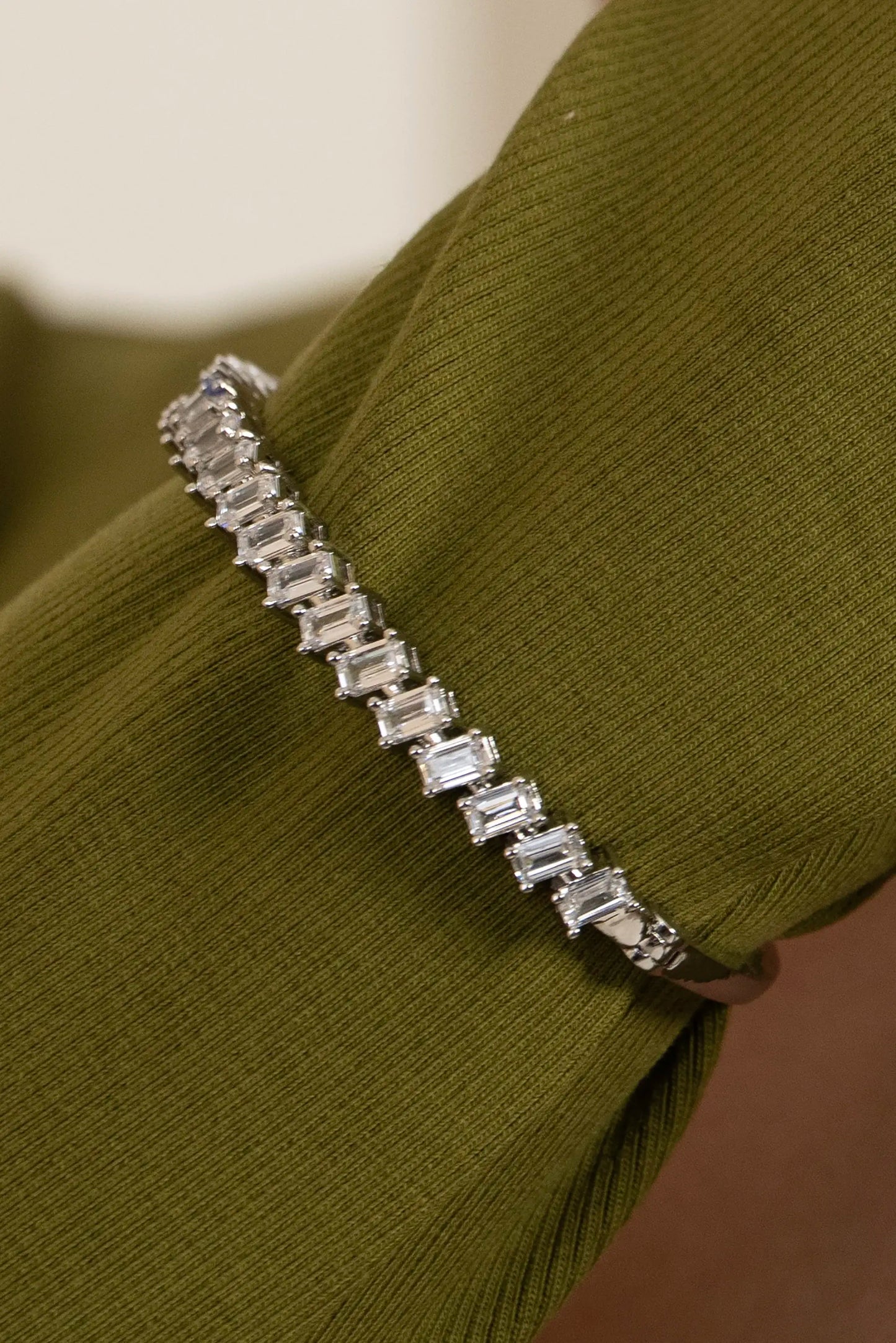 Fashion jewelry macro of a silver diamond bracelet with rectangular stones, modern wrist accessory