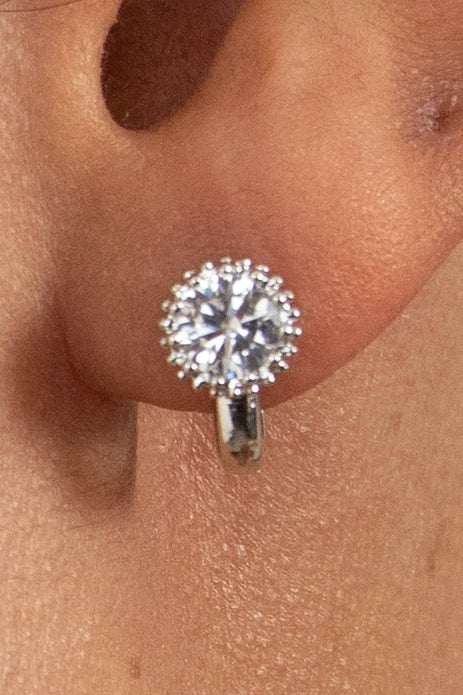 Classic round diamond stud earring with halo design, minimal and timeless jewelry style
