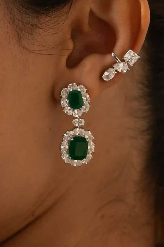 Tiramisu Jewellery emerald drop chandelier earrings with deep green stones and cygnet diamond detailing in a graceful cascading design