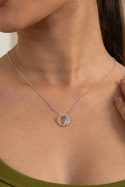 Open circle diamond pendant set with minimal chain and matching cluster stud earrings on model in olive green outfit