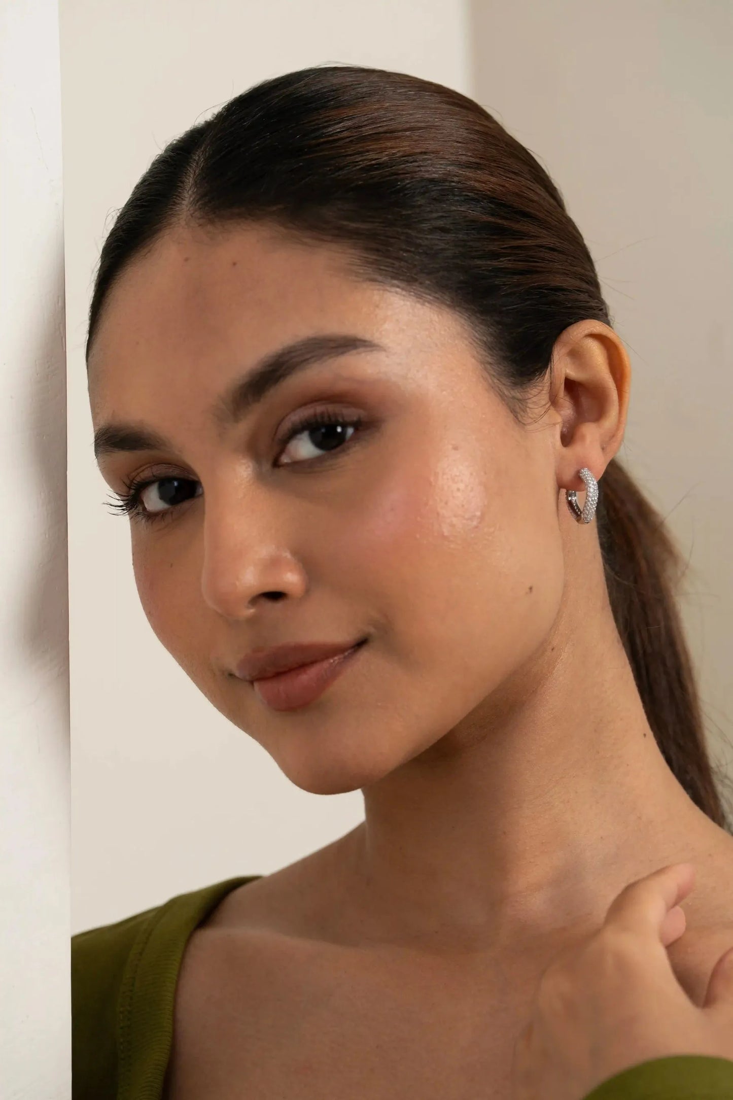 Elegant diamond-studded hoop earring on ear, showcasing premium craftsmanship and shine