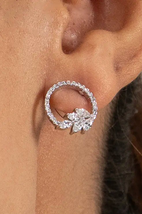 Elegant open circle diamond pendant necklace with cluster earrings styled on modern model in soft studio lighting
