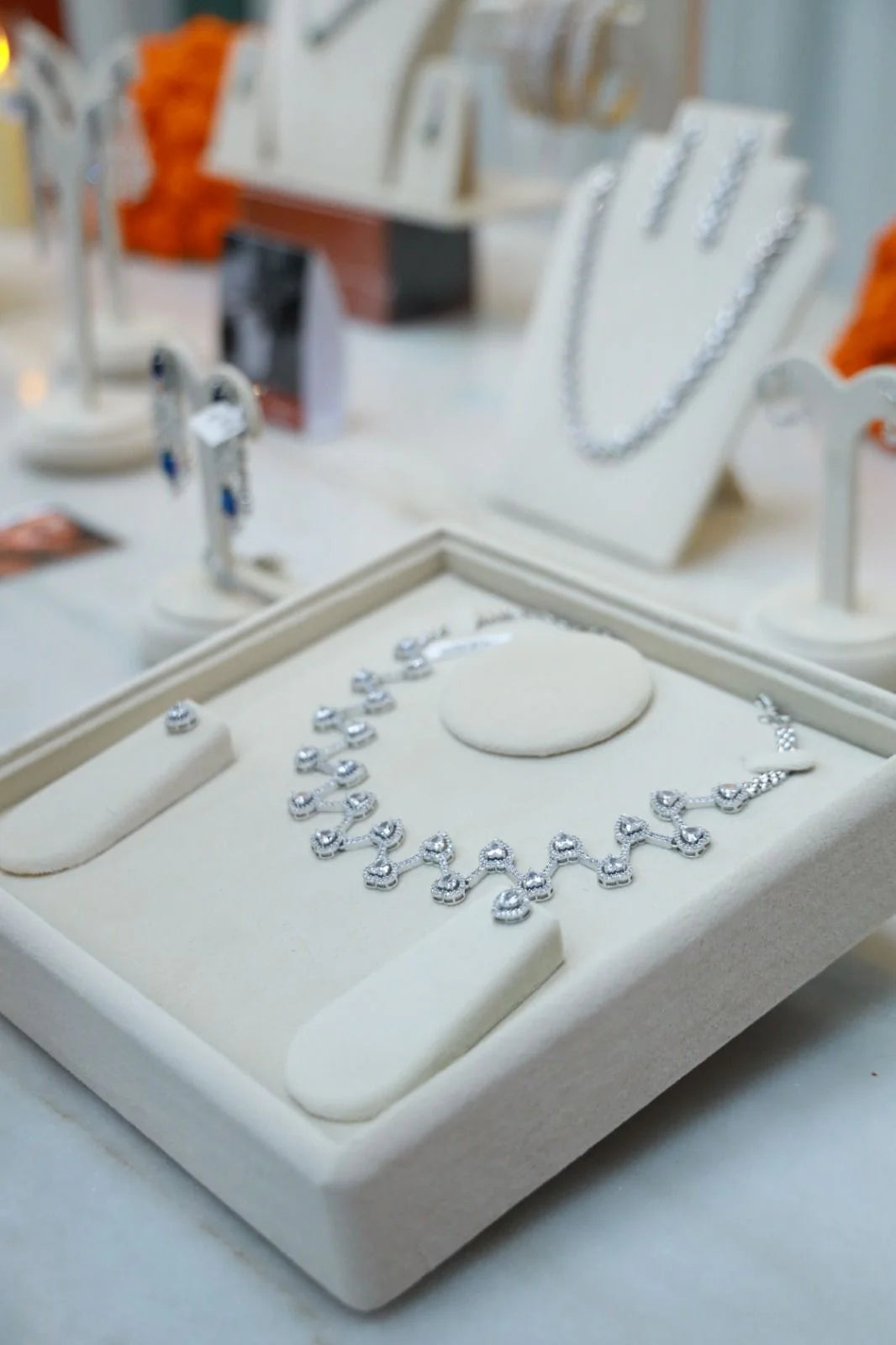 Luxury jewelry close-up featuring diamond necklace on woman with smoky eyeshadow and styled hair
