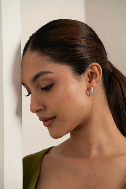 Contemporary pavé diamond hoop earring on ear, highlighting elegant everyday jewelry style