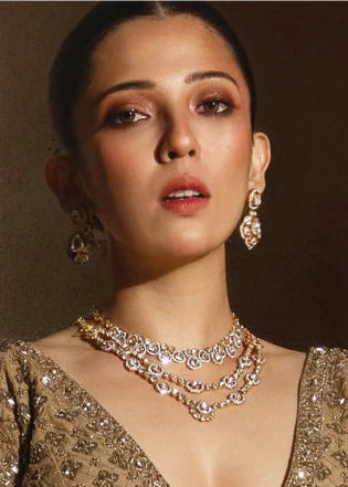 Elegant beauty shot highlighting a woman adorned with cascading diamond necklaces and coordinated statement earrings.

