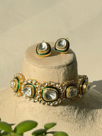 Traditional gold and green choker necklace with clear stones showcased with matching earrings
