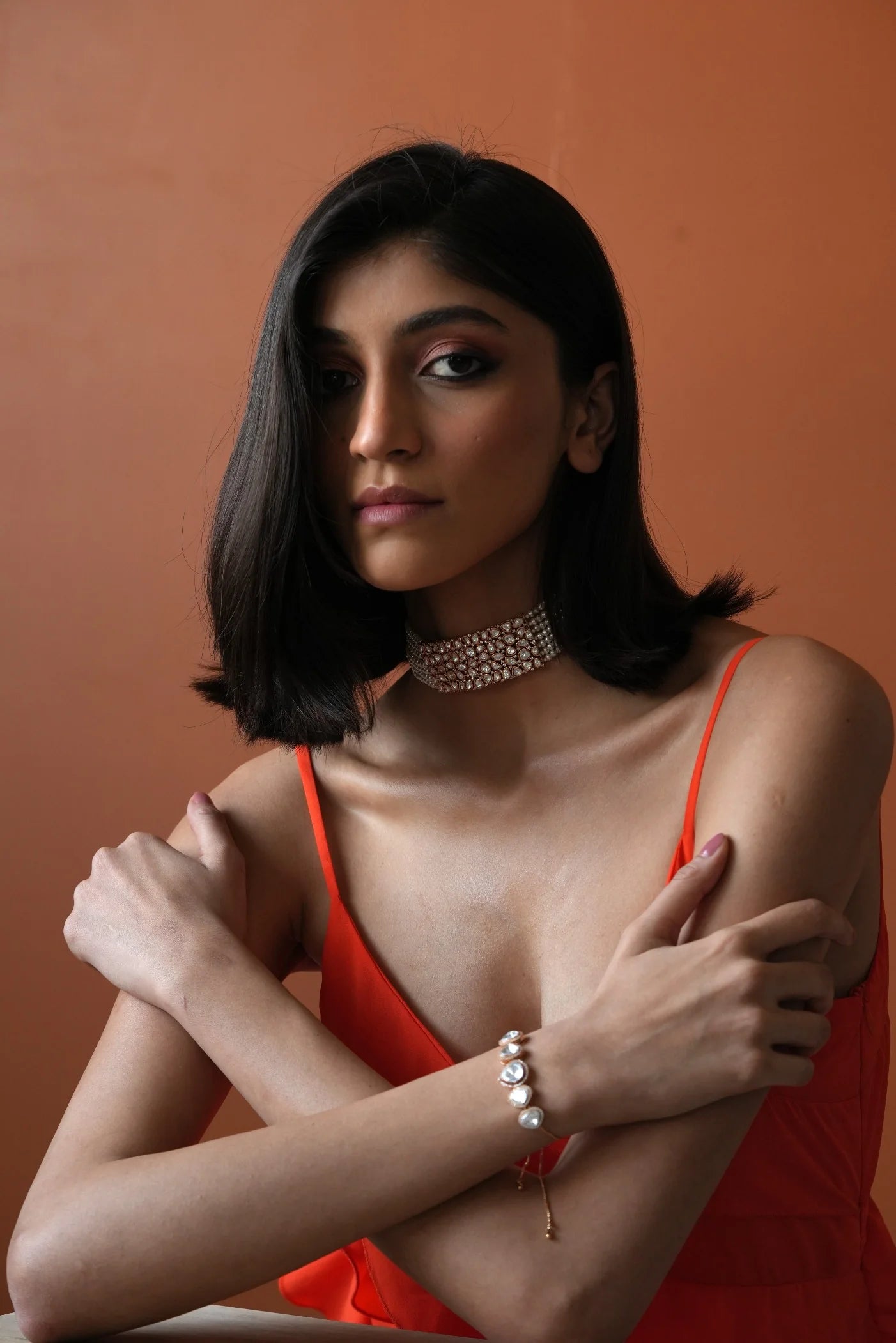 Refined portrait of a woman wearing stacked diamond rings and a delicate necklace, emphasizing a chic and contemporary aesthetic.
