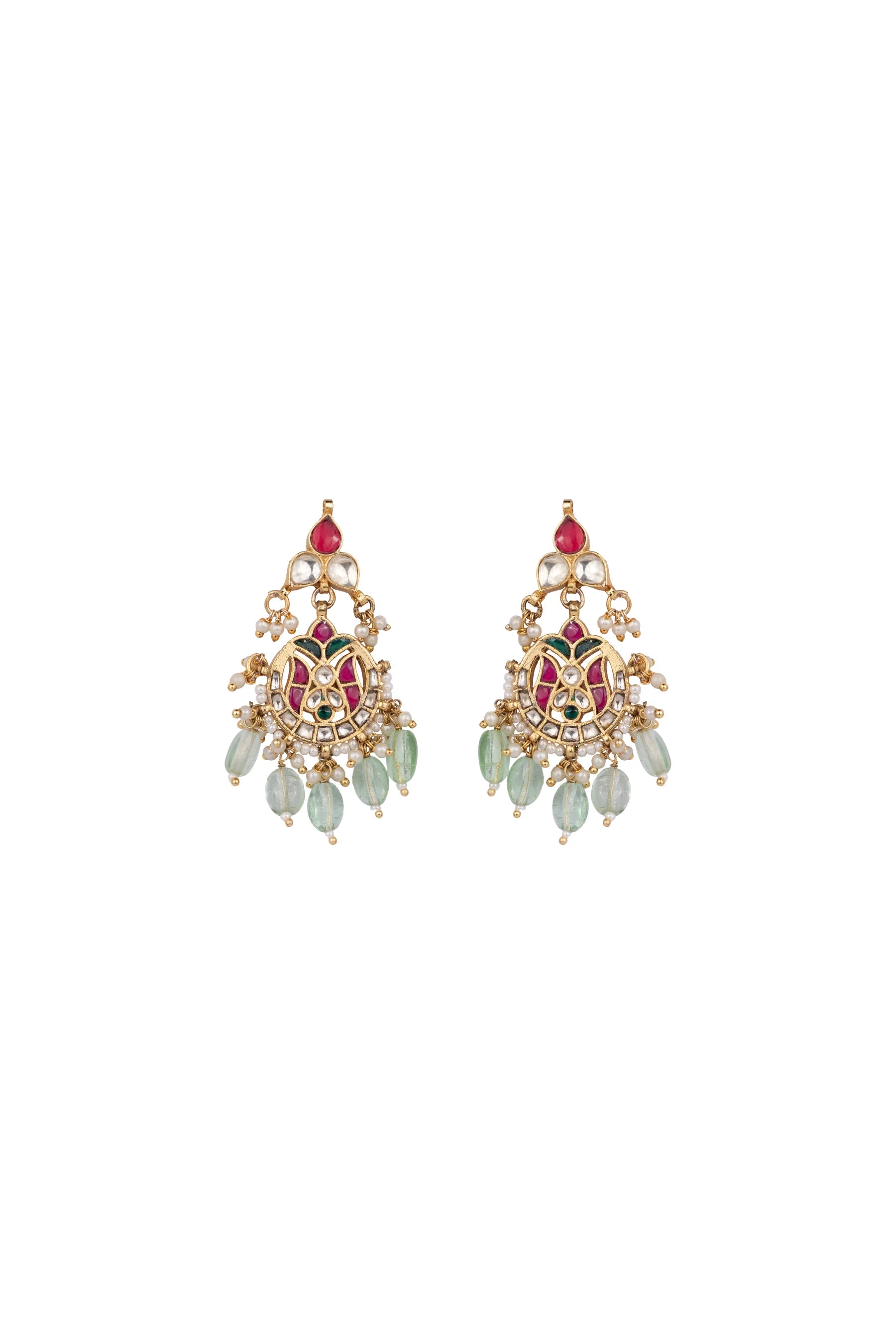 Artistic close-up of a woman in warm light wearing statement earrings with layered detailing and a festive outfit.
