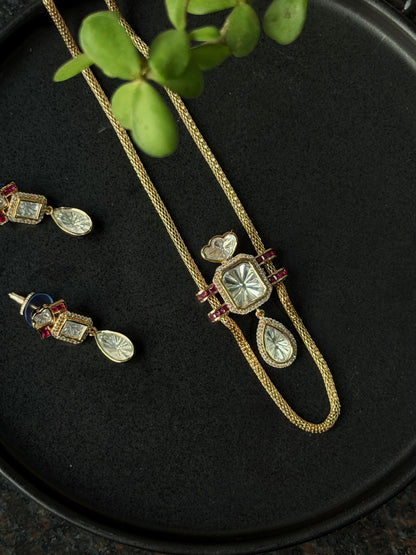 Elegant gold jewelry set with crystal pendant necklace and matching drop earrings with ruby details

