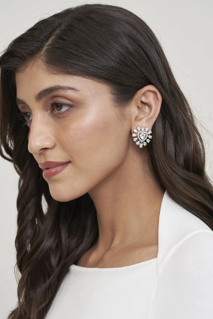 Fine jewelry close-up showcasing a clustered diamond earring in a romantic heart-inspired design with intricate detailing.
