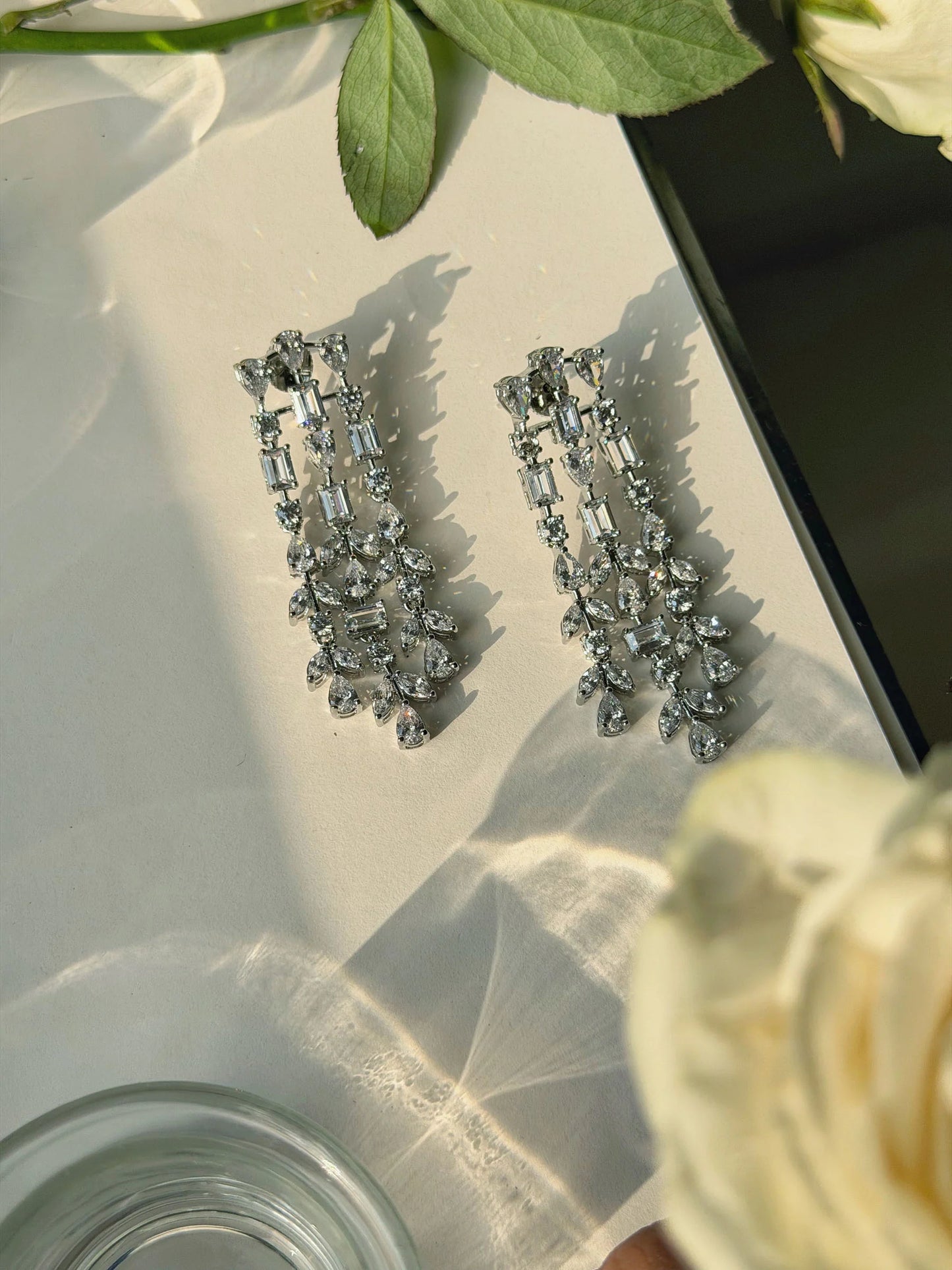 Fashion jewelry shot of long crystal chandelier earrings on dark background
