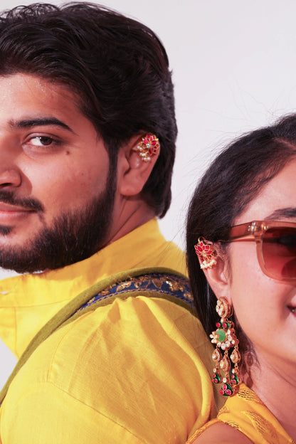 Traditional gold earrings with red centerpiece and shimmering crystal embellishments

