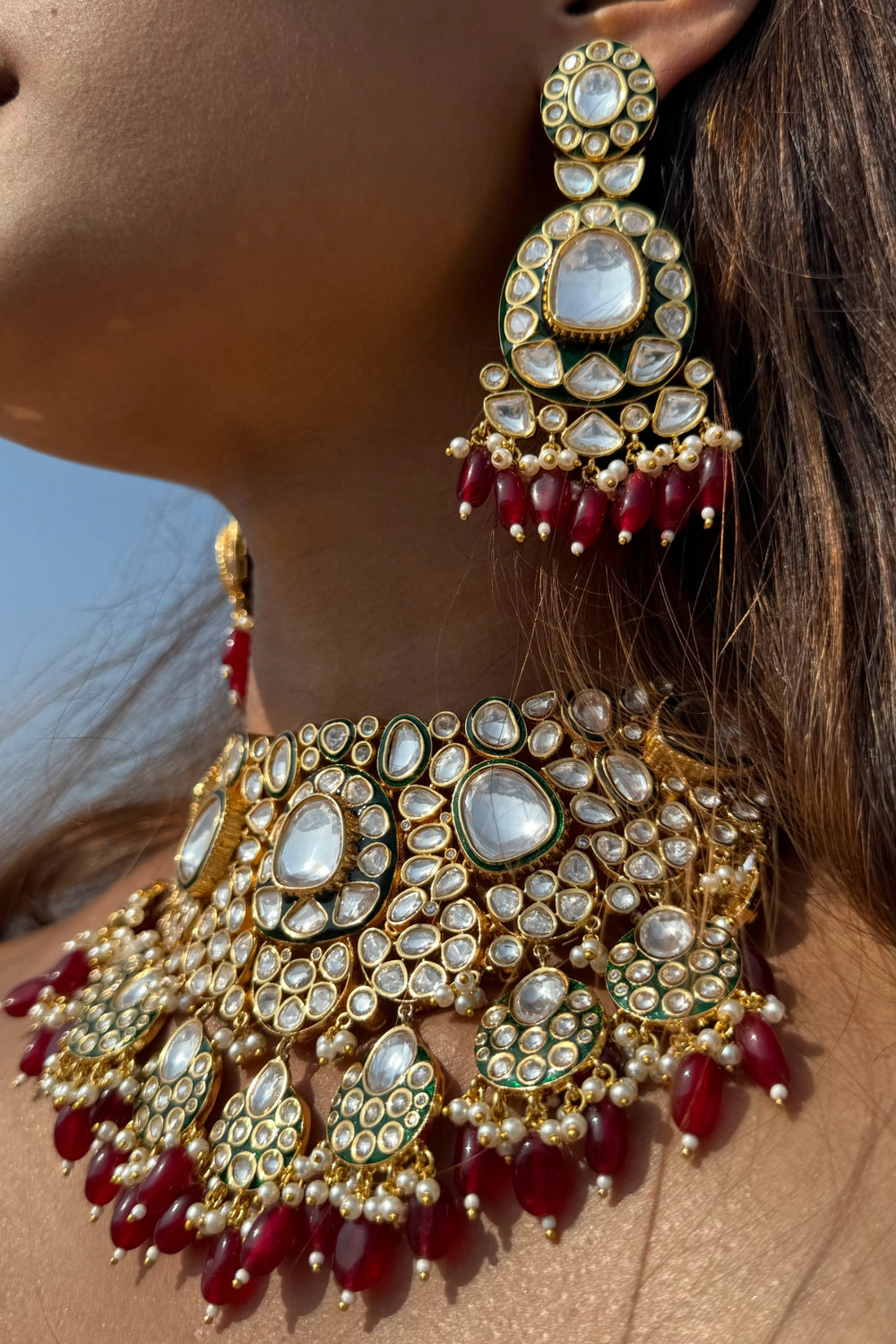 red semi-precious stone necklace with polki earrings