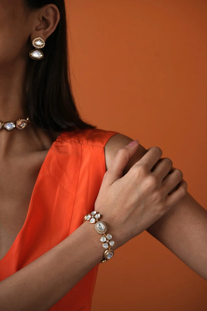 Elegant woman wearing a statement diamond choker, styled with a soft neutral outfit and minimal background.
