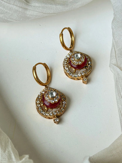 Traditional gold earrings with red enamel center and diamond-like crystal embellishments
