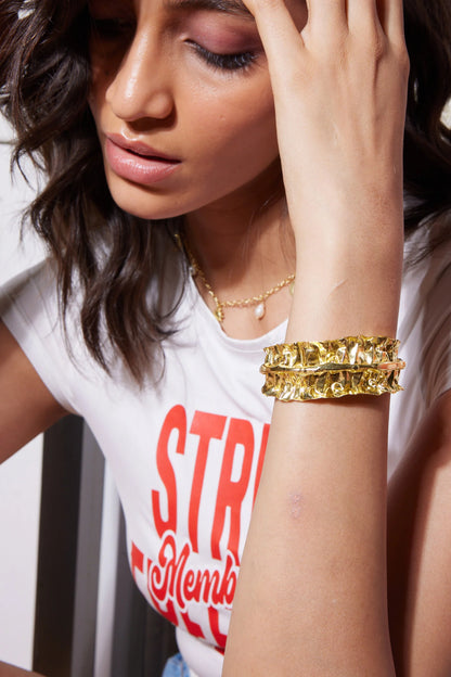 Fun food and lifestyle image of a woman holding a cake and licking frosting near an open fridge
