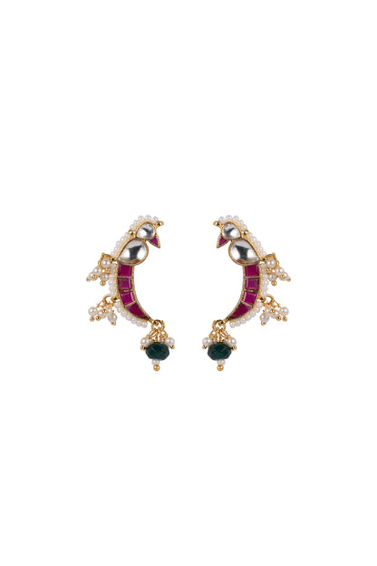 Fine jewelry detail of a handcrafted crescent ring featuring bright gemstone accents and intricate pearl work, worn on a softly lit hand.
