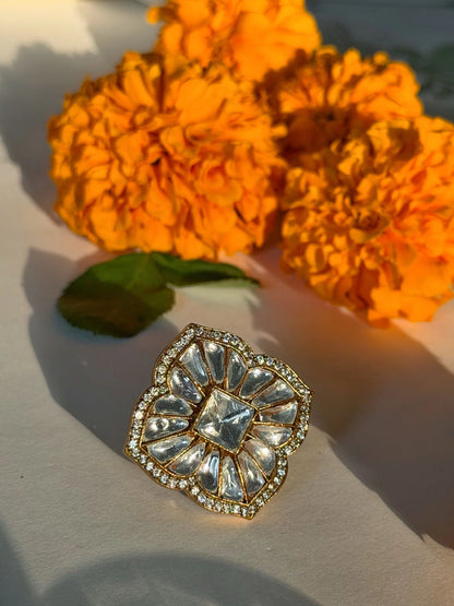 Premium gold ring with floral motif and sparkling stones on aesthetic festive background
