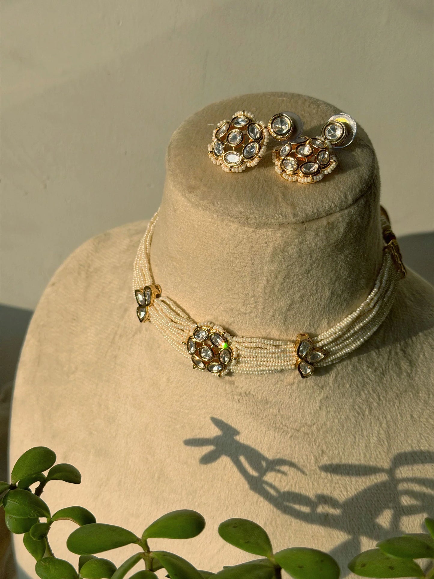 Premium Indian wedding choker with kundan work and teardrop pendant on mannequin bust
