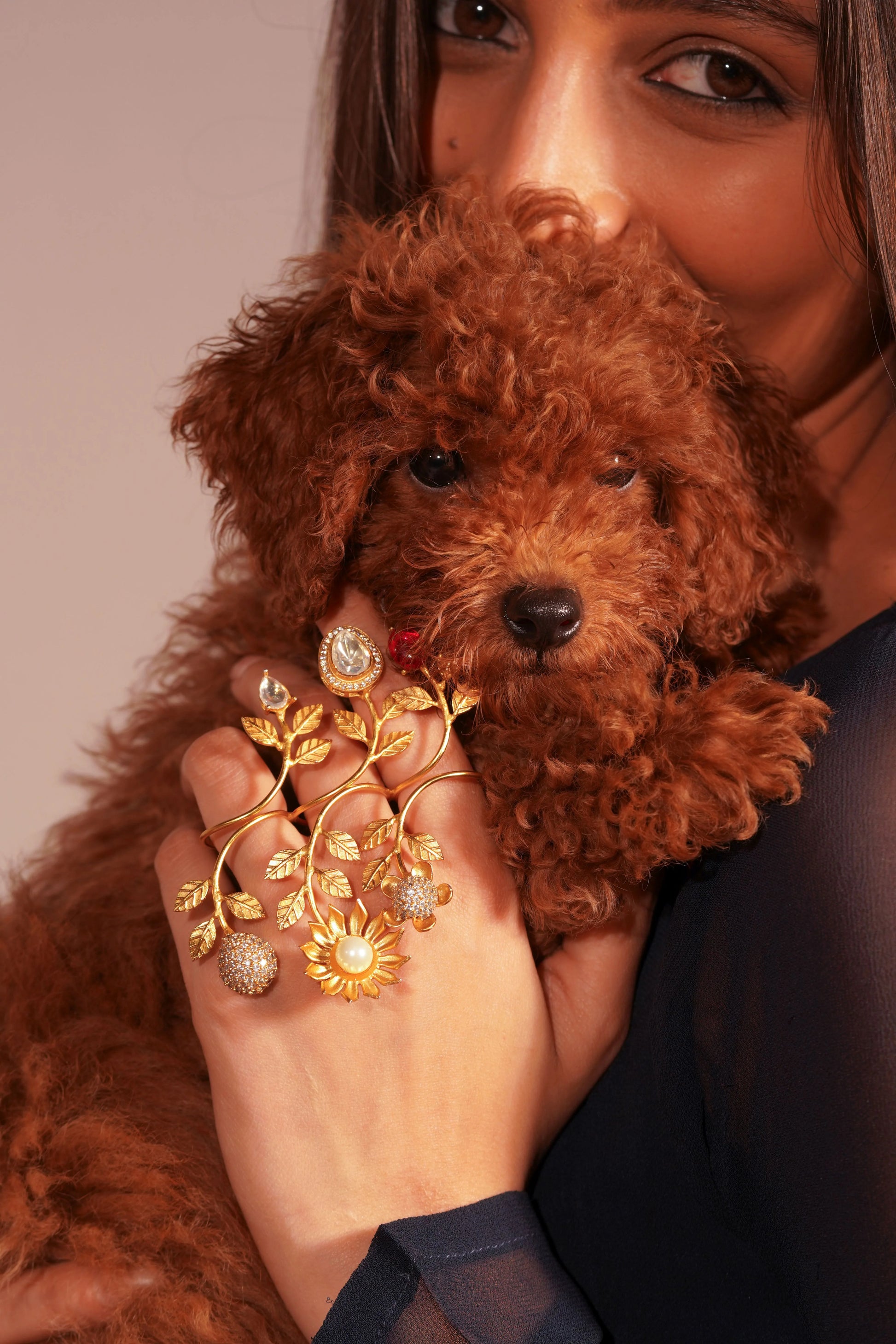 Fashion portrait of woman showcasing gold hand harness jewelry with pearl and gemstone details
