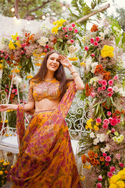 Graceful portrait of a woman in a peach and green saree combination with intricate embroidery and accessories
