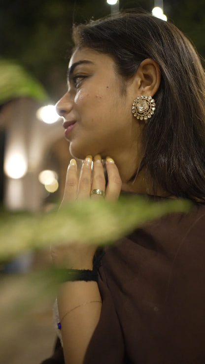 Traditional Indian home celebration with woman decorating altar using flowers and diya
