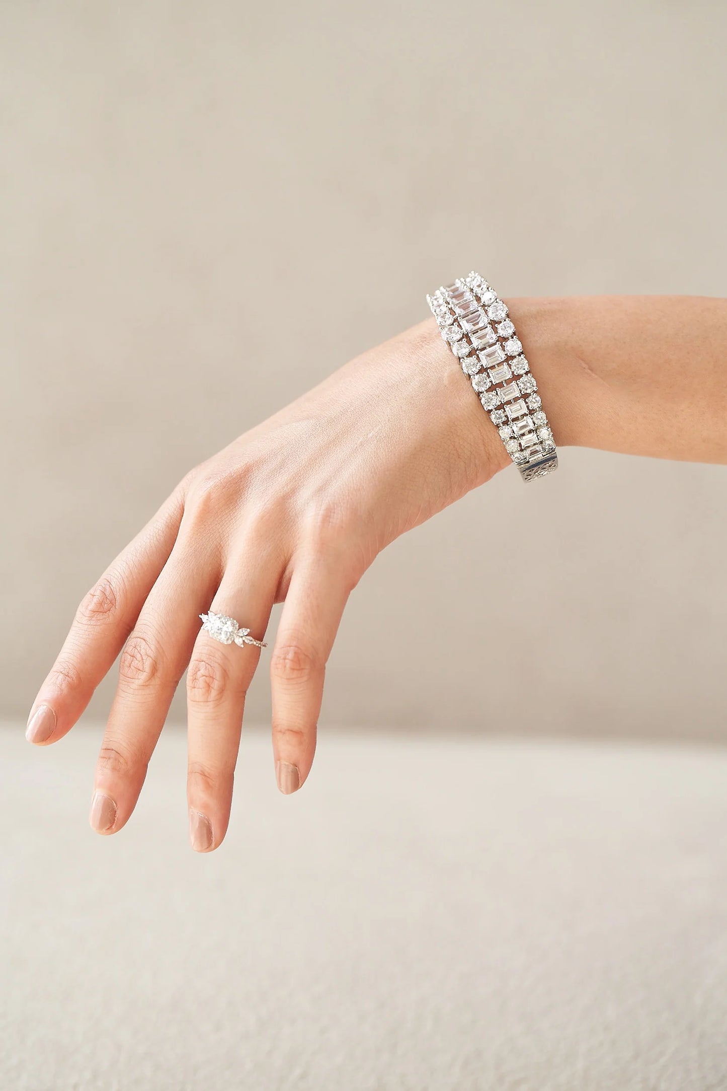 Fine diamond ring with a soft cushion center stone and tapered marquise details, creating a floral-inspired silhouette.
