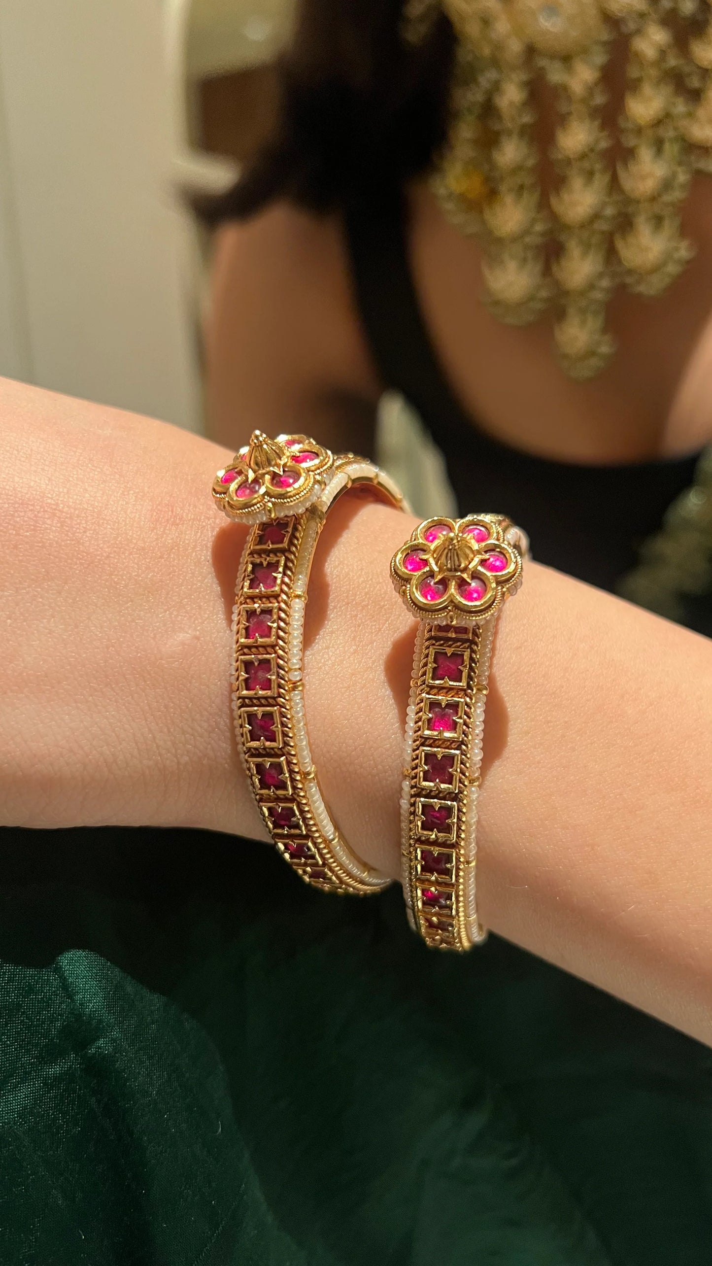 Elegant portrait detail highlighting a gemstone-studded hoop earring with contrasting stones against soft sunlight.
