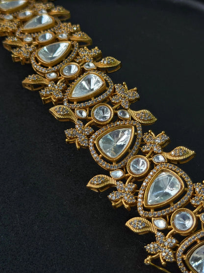 Elegant gold jewelry bracelet with crystal stones and detailed craftsmanship in close-up
