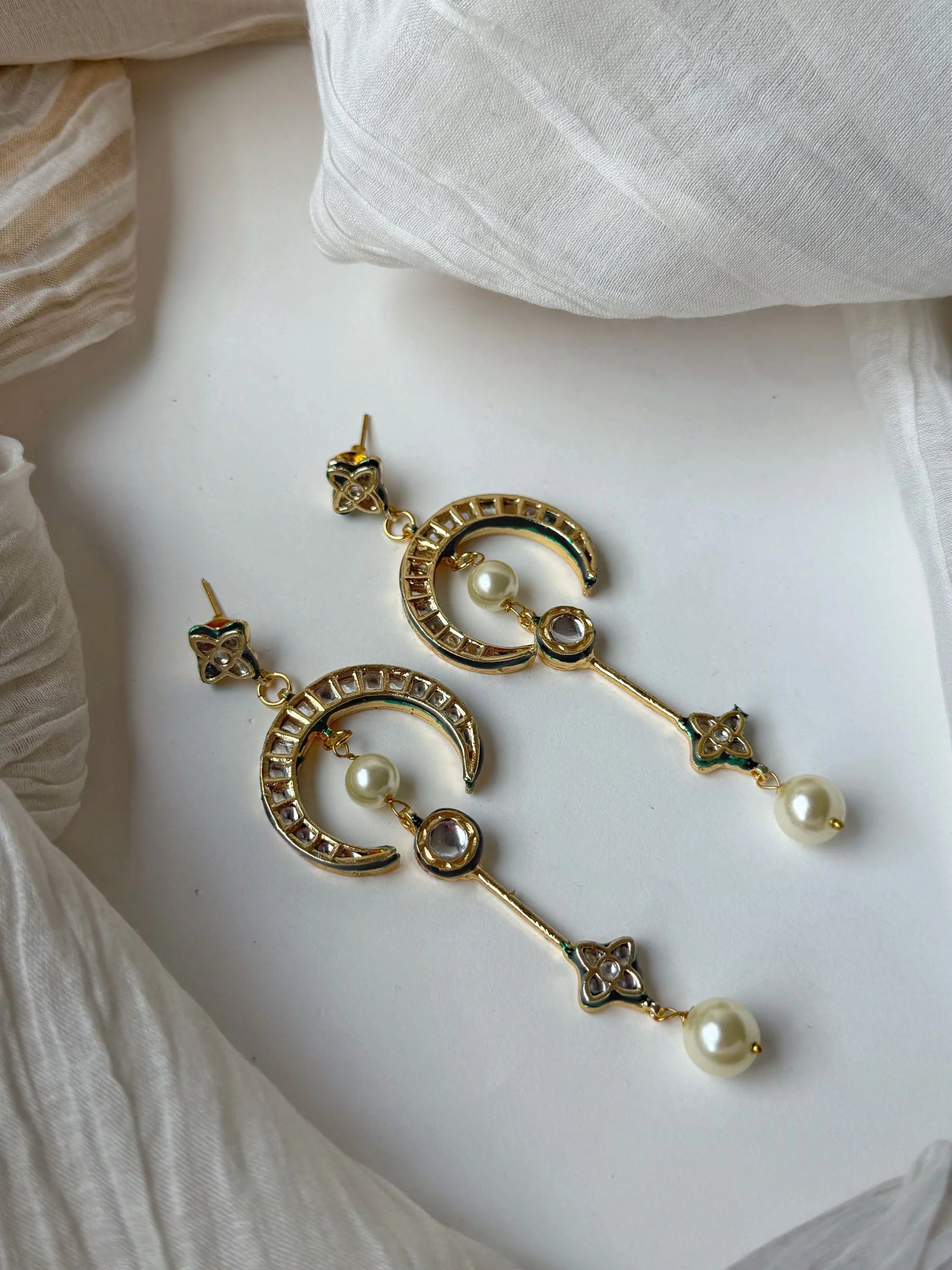 Premium crescent hoop earrings with pearls and kundan stones in minimal jewelry styling
