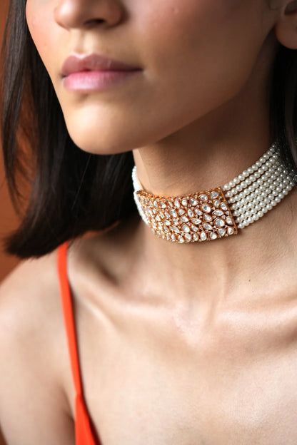 Fine jewelry portrait featuring a sparkling choker necklace with clustered stones, paired with a minimal cream-toned look.
