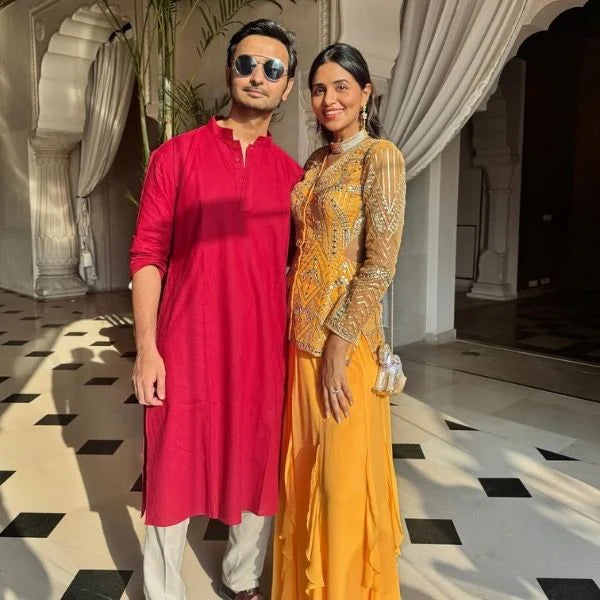 Modern styling image highlighting a statement choker necklace with multiple rows of shimmering stones in a clean indoor setting.
