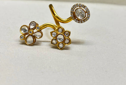 Elegant gold adjustable ring with flower motifs and clear gemstones in detailed close-up accents
