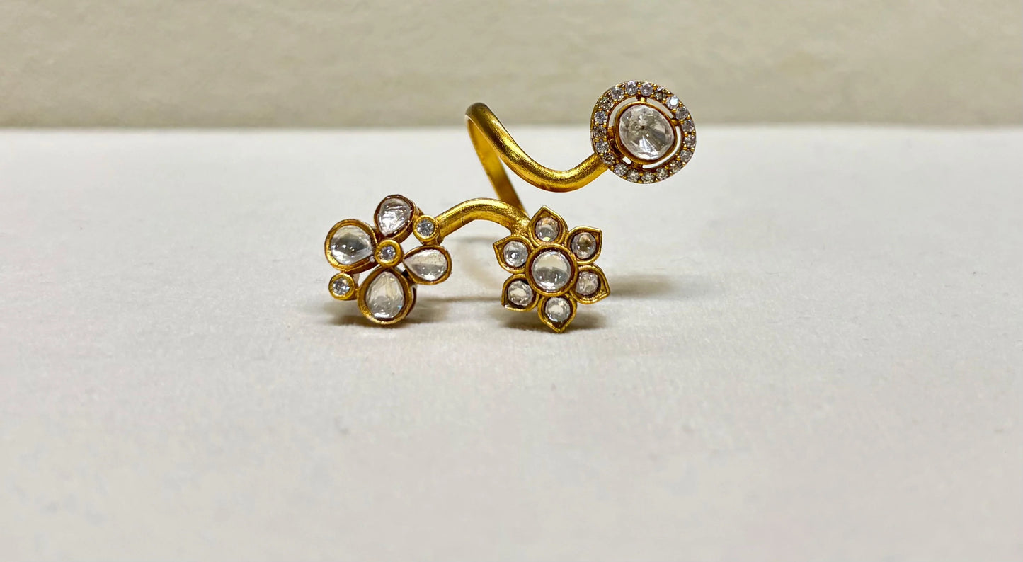 Elegant gold adjustable ring with flower motifs and clear gemstones in detailed close-up accents
