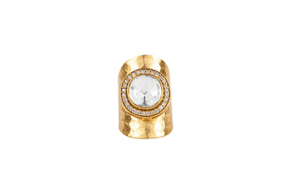 Detailed view of gold jewelry set with bracelets and rings styled on hands in a vintage car setting
