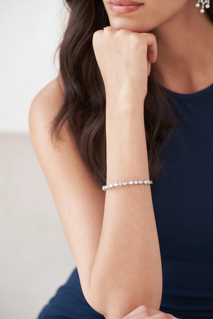 Minimalist diamond line bracelet with alternating gemstone shapes creating a refined, modern sparkle across the wrist.
