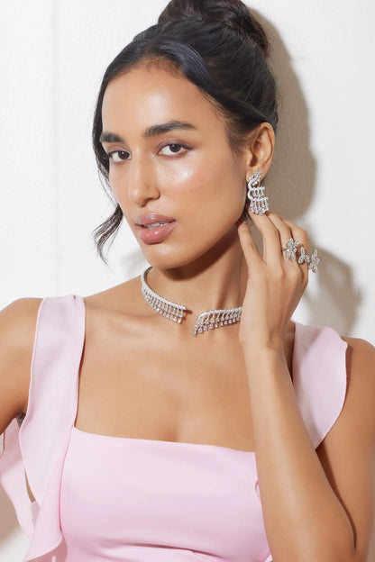 Modern fashion shoot of woman in embellished blazer with layered luxury jewelry
