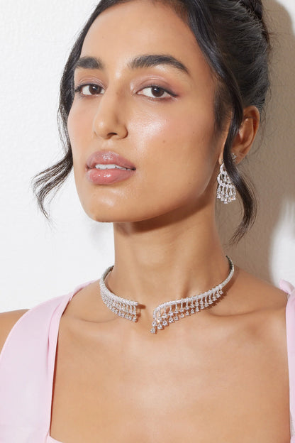 Sophisticated portrait of model in cream jacket with ornate shoulder details and fine jewelry
