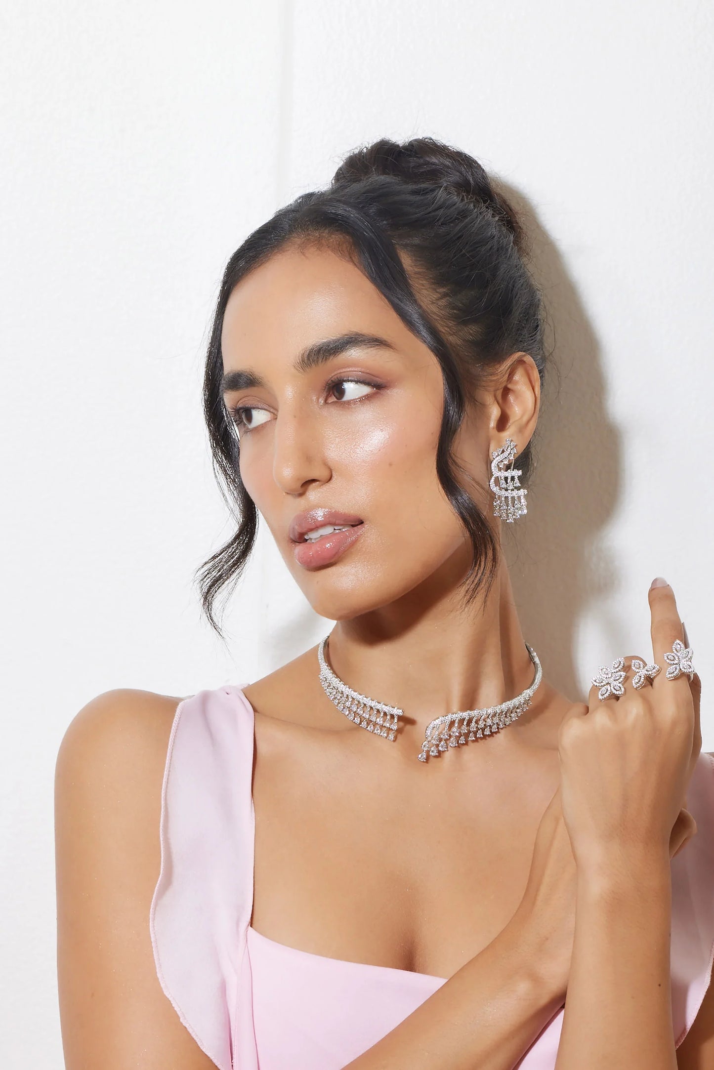 Premium jewelry styling with cream blazer and multi-layered necklace set on female model
