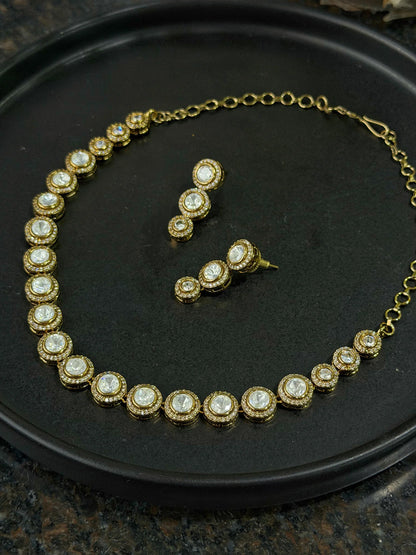 Premium gold necklace with round gemstone links and coordinated drop earrings display
