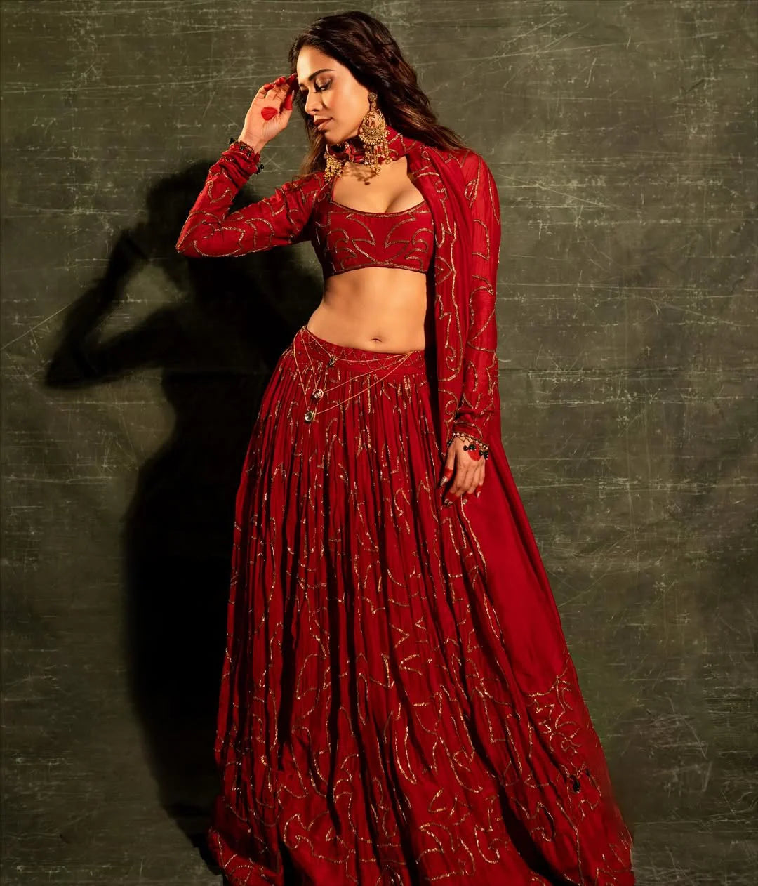 Traditional Indian fashion look with red lehenga and statement earrings
