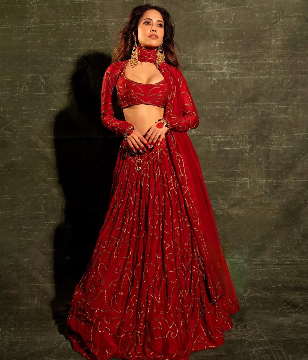 Stylish ethnic fashion featuring red embroidered lehenga and matching blouse
