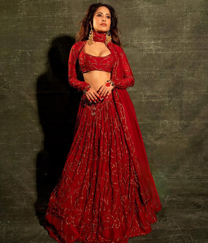 Stylish ethnic fashion featuring red embroidered lehenga and matching blouse
