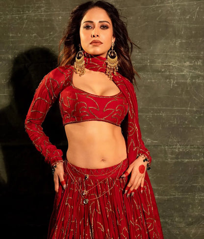 Glamorous portrait of woman in red traditional attire with heavy jewelry
