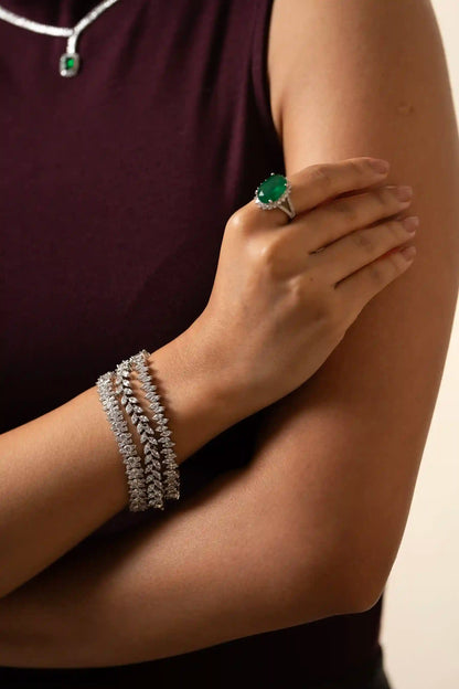 Macro close-up of oval emerald ring with diamond halo and split shank band, luxury statement jewelry piece