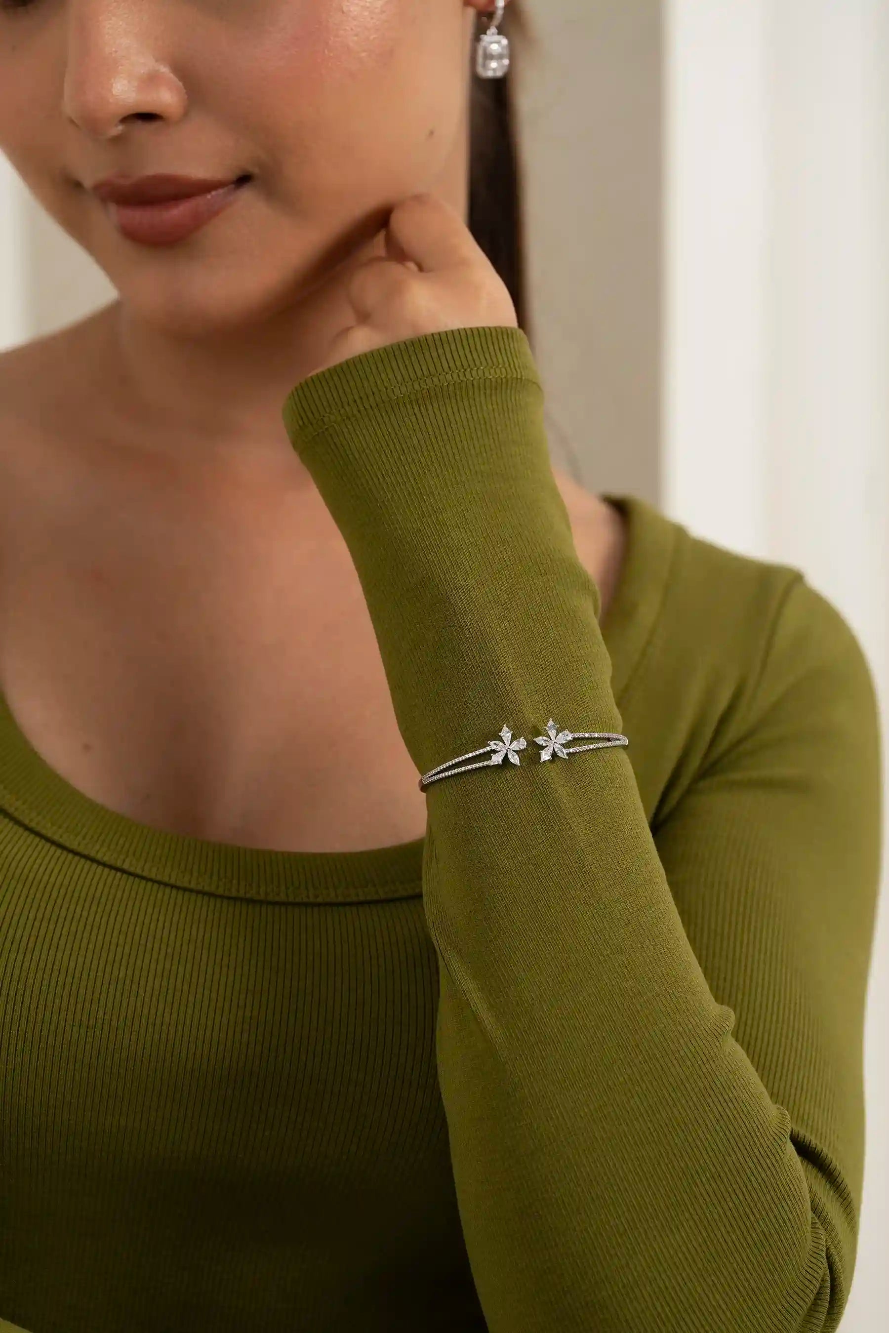 Stylish flower motif diamond bracelet on wrist, contemporary women’s jewelry trend