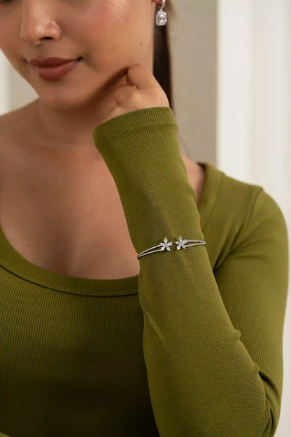 Stylish flower motif diamond bracelet on wrist, contemporary women’s jewelry trend